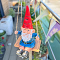 Garden gnome in a swing ornament.